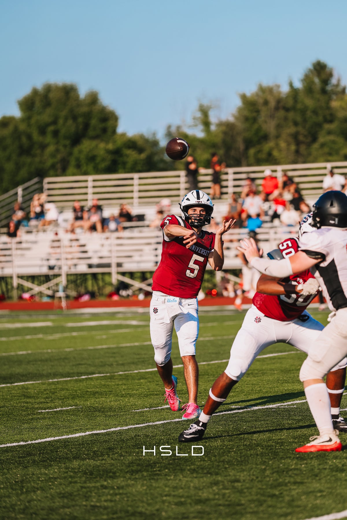 Quarterback releasing a pass during a football game.