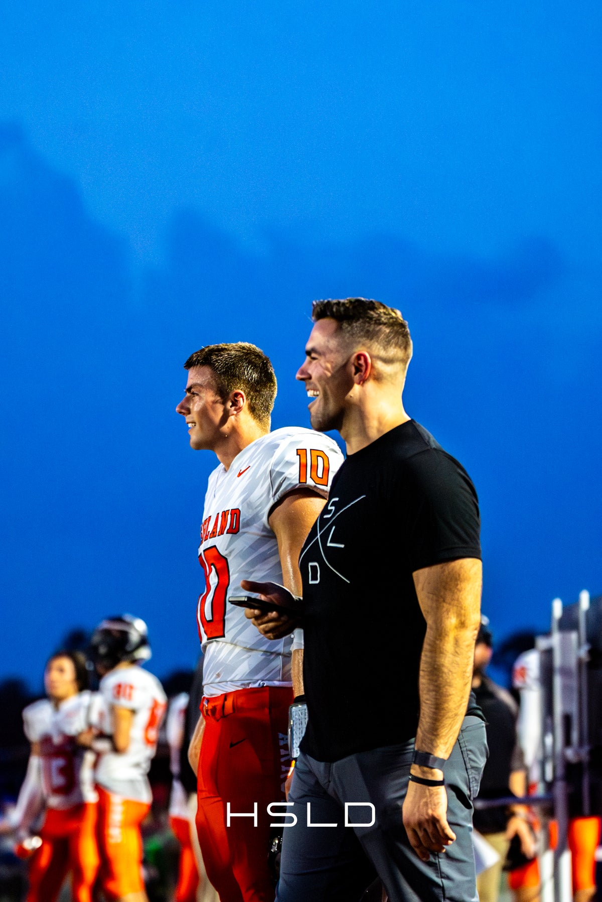 Zach and Nathan Bernhard together on the football sideline.